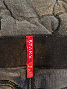SPANX Black Denim Leggings with ripped Knee. Fringed ankle